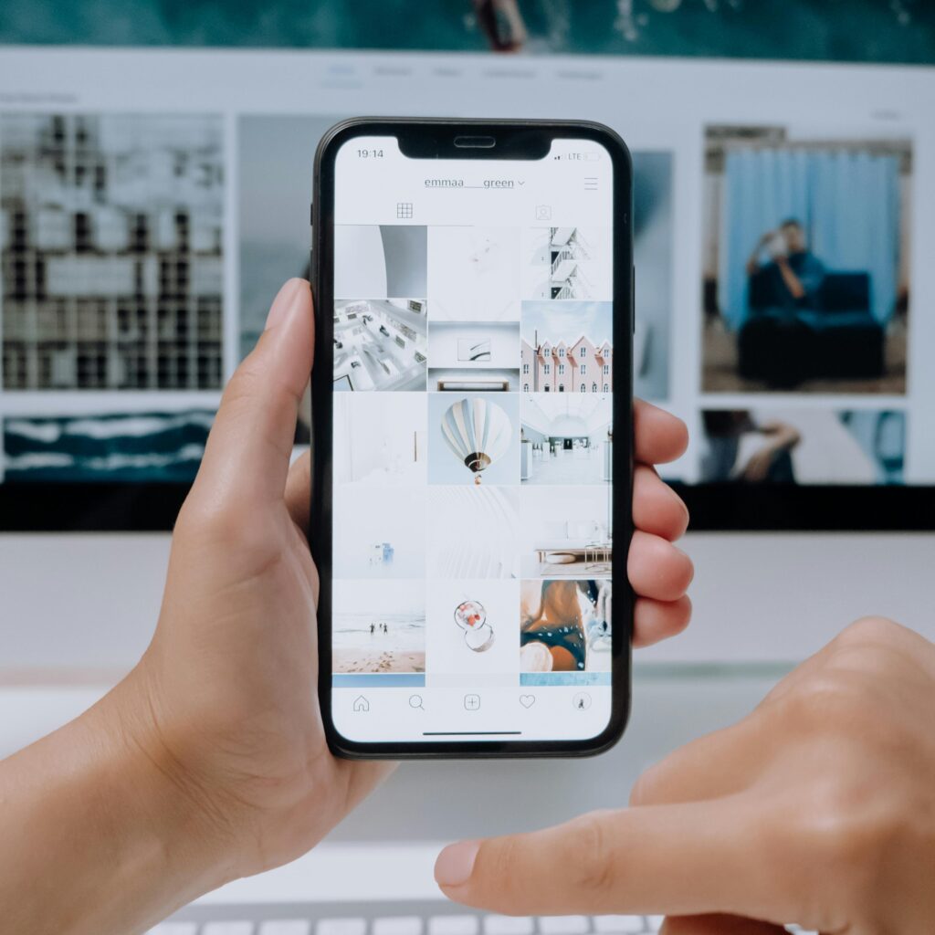 A digital marketer organizing a monthly content calendar with a notebook and laptop for strategic planning.

