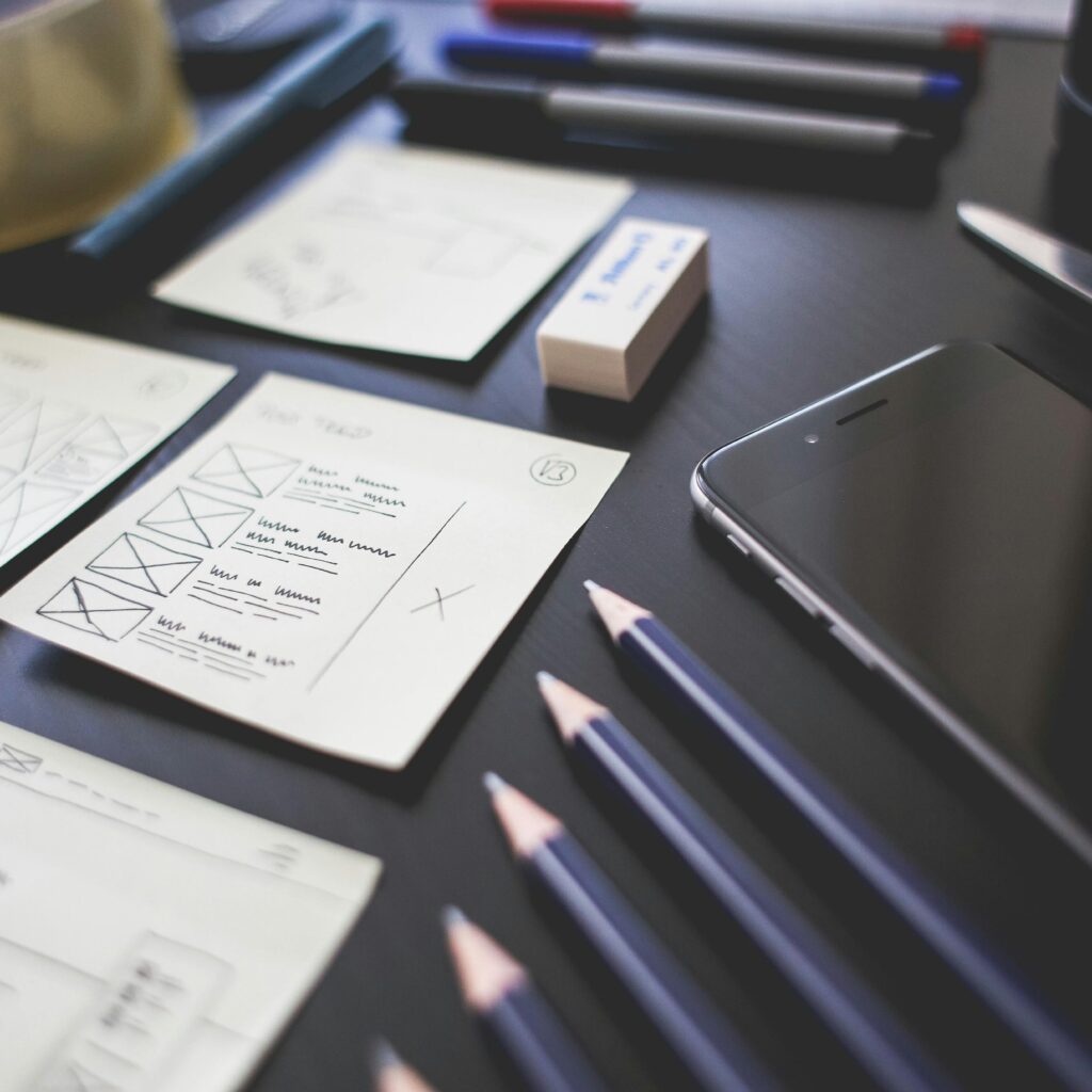 A creative marketing team brainstorming a digital content strategy for 2025 using laptops and data.

